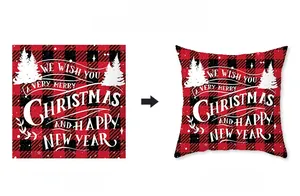 Detail of Christmas red buffalo plaid pillow cover featuring white festive typography
