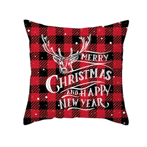 Red and black buffalo plaid Christmas pillow cover with white reindeer and holiday greeting