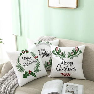 Christmas pillow covers with reindeer horns and Merry Christmas text on sofa
