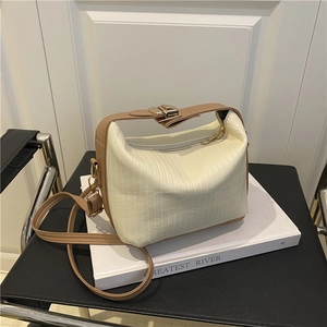 Minimalist cream white pleated handbag with brown leather strap and gold clasp buckle