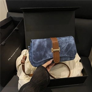 French retro denim underarm bag with brown leather strap and gold buckle in a gift box