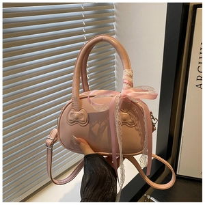Detail of pink shell bag featuring embossed 3D bows and lace ribbon on the handle