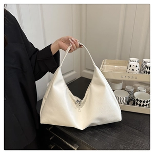 Close-up of white matte lychee pattern hobo bag with dual silver zipper detail
