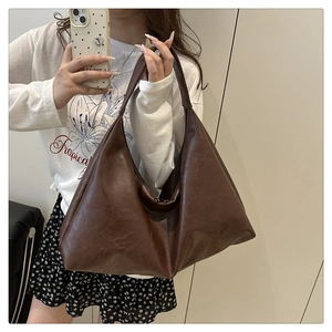 Detailed view of the dark brown hobo bag with vintage leather texture and large capacity