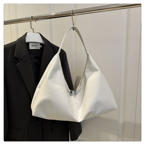 Detail of white large capacity tote bag with silver double zippers and soft leather texture