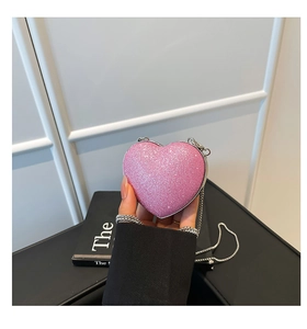 Close-up of pink glitter heart-shaped mini bag with a delicate silver chain strap