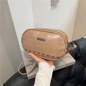 Chic beige crossbody bag with silver rivets and dual zipper closure for summer commute