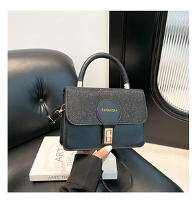 Close-up of black sequin patchwork handbag with gold square twist lock and Fashion logo