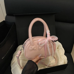 Pink shell handbag with bow embossing and lace ribbon in a premium gift box setup