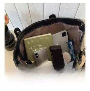 Top view of large black leather tote bag showing spacious interior with personal essentials