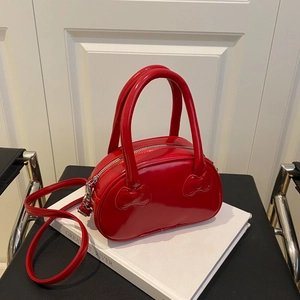 Glossy red sweet bowling bag with heart stitching and adjustable strap for women