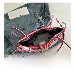 Top view of denim handbag with red gingham trim showing large interior storage capacity