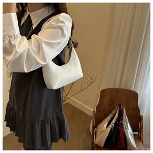 Fashionable minimalist half-moon underarm bag in glossy white leather shown with variety colors