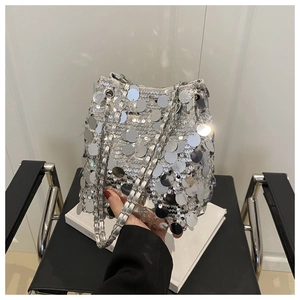 Detailed view of silver sequin bucket bag with round metallic scales and chain strap