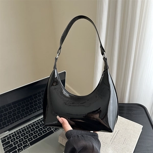 Glossy black patent leather hobo bag with minimalist half-moon shape for daily use