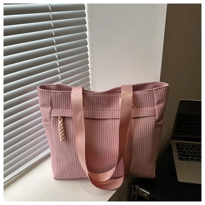 Macro detail of pink woven tote bag showing 3D wave texture and wide nylon straps