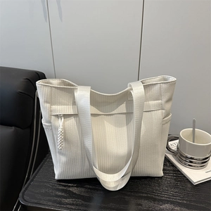 Minimalist white tote bag with wave texture and woven strap for summer commute