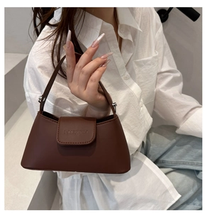 Detailed shot of coffee brown matte PU leather handbag with embossed FANYISSA logo