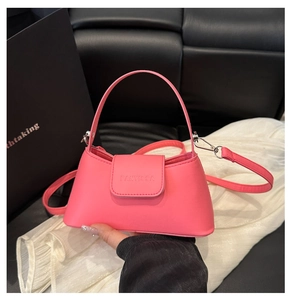 Detail of pink PU leather handbag showing brand embossing and polished silver hardware