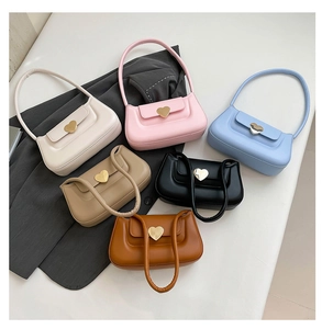 Flat lay of colorful mini heart-buckle underarm bags in pastel and classic tones