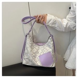 Detail of light purple floral embroidery on fabric tote bag with leather straps