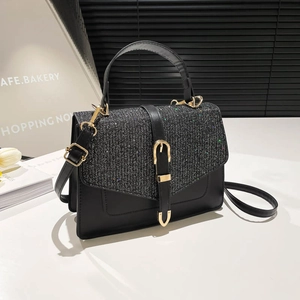 Modische schwarze Handtasche mit Glitzer-Klappe und goldener Schnalle in der Vorderansicht