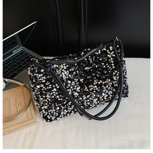 Detail of shimmering black and silver sequins on high-capacity baguette shoulder bag