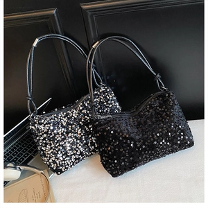 Detail view of two sequin shoulder bags with knotted handles and metallic texture