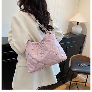 Close-up of pink quilted crossbody bag with sparkling rhinestones and star accent
