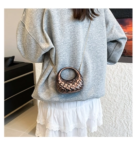 Detailed view of bronze acrylic mini crossbody bag with diamond lattice pattern and chain