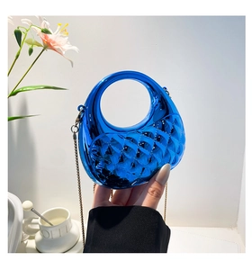 Detail of blue quilted candy color mini handbag with gold chain and round handle