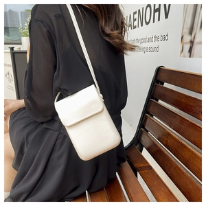 White minimalist vertical crossbody phone bag with flap closure and adjustable strap