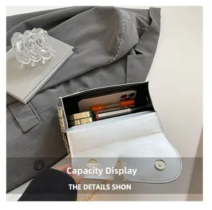 Silver metallic evening clutch interior showing capacity for phone and cosmetics