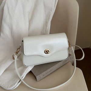 Minimalist white rectangular crossbody bag with golden rotary buckle and leather texture