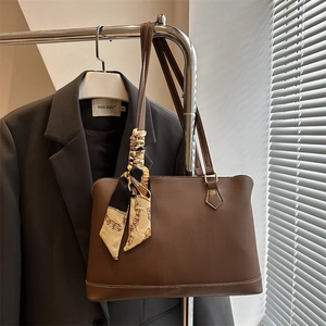 Brown leather tote bag with decorative patterned silk scarf for office commuting style