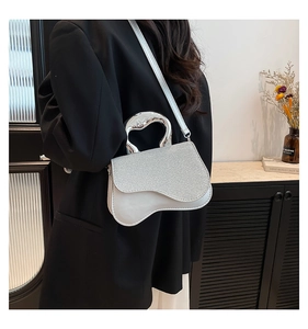Chic silver crossbody bag with glitter texture shown in a modern lifestyle setting