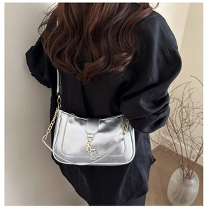 Silver metallic baguette bag with gold chain strap shown on model for size and fit