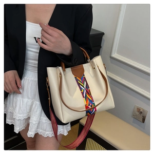 Detailansicht der cremefarbenen Tasche mit buntem geometrisch gewebtem breitem Schultergurt