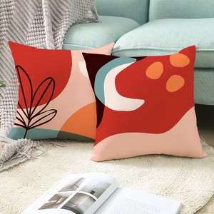Abstract Morandi geometric throw pillow covers set in red and orange on a plush white rug