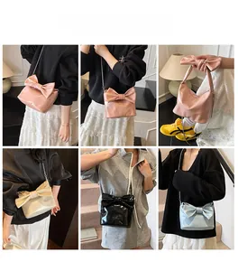 Detail view of stylish tote bag with large bow and metallic chain strap in four colors
