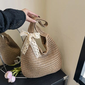 Chic straw tote bag with lace bow decoration and half-moon woven texture for summer beach