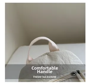 Close-up of comfortable reinforced fabric handles and metal zipper on nylon travel backpack