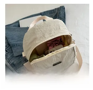 Detail of off-white wrinkled nylon backpack interior with large capacity for essentials
