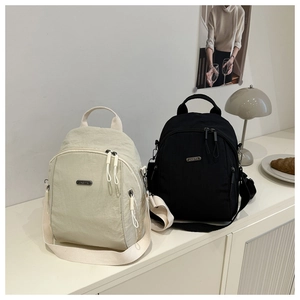 Close-up of the versatile backpack featuring multi-zipper pockets and wide fabric straps