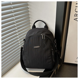 Close-up of black nylon multi-way backpack with metallic JING PIN logo and zipper details