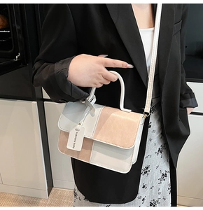 Detail of trendy color-block crossbody bag with Fashion & Bags tag and top handle