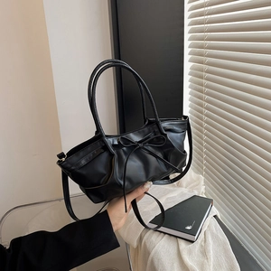 Black pleated tote bag with bow detail and adjustable shoulder strap for women