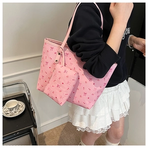 Pink tote bag detail with floral bow prints and matching mini pouch for daily use