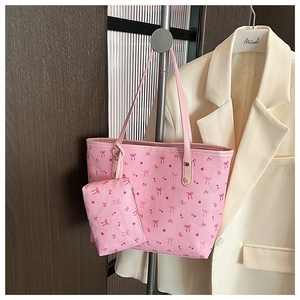 Detailed shot of pink floral tote bag set featuring cherry prints and matching coin purse