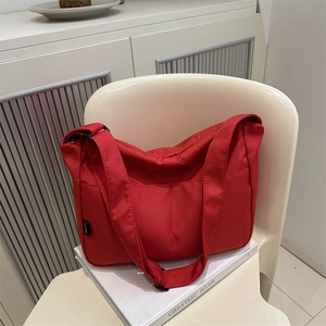 Vibrant red nylon shoulder bag for women with waterproof fabric and fashion side label